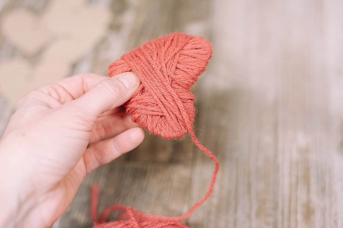 wrap yarn around cardboard heart cutout shape