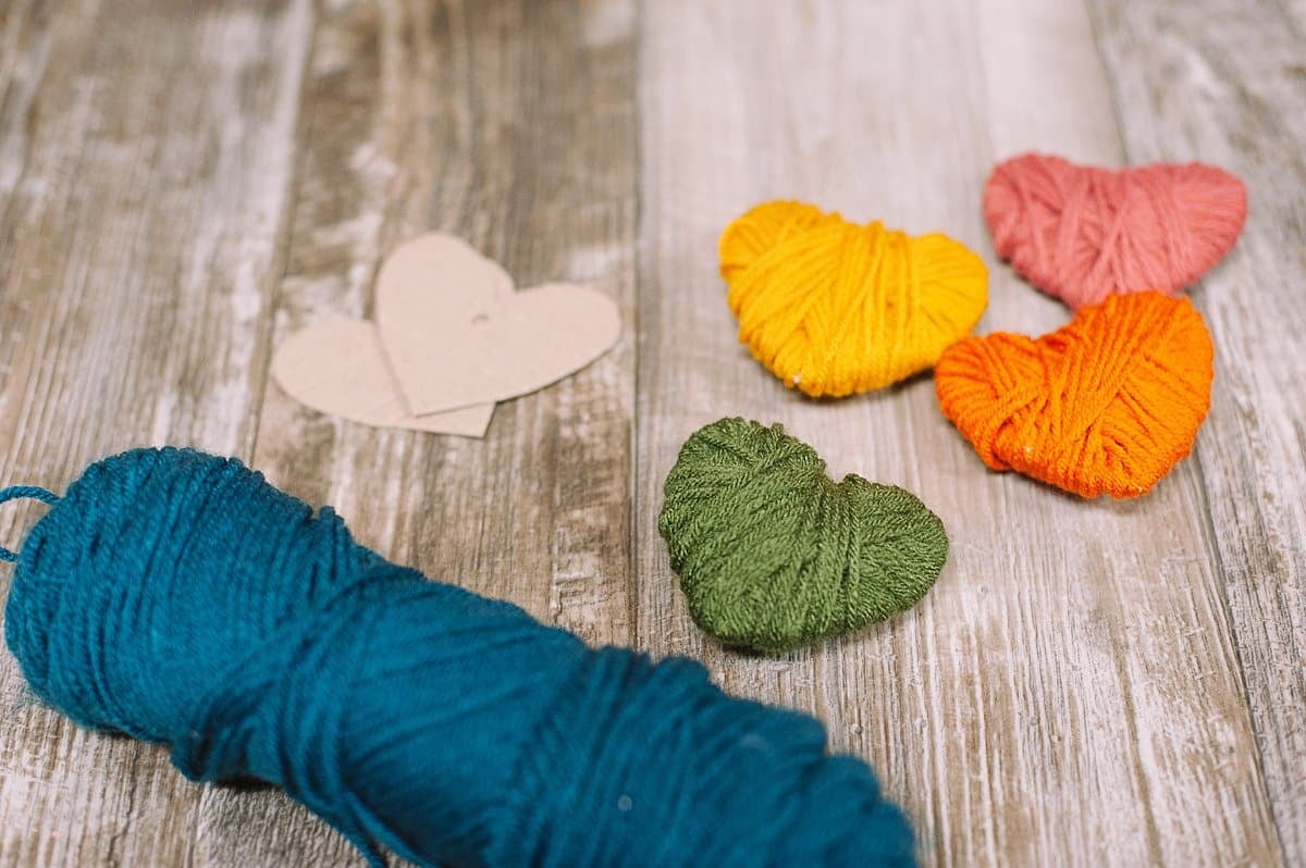 Yarn-wrapped cardboard hearts.