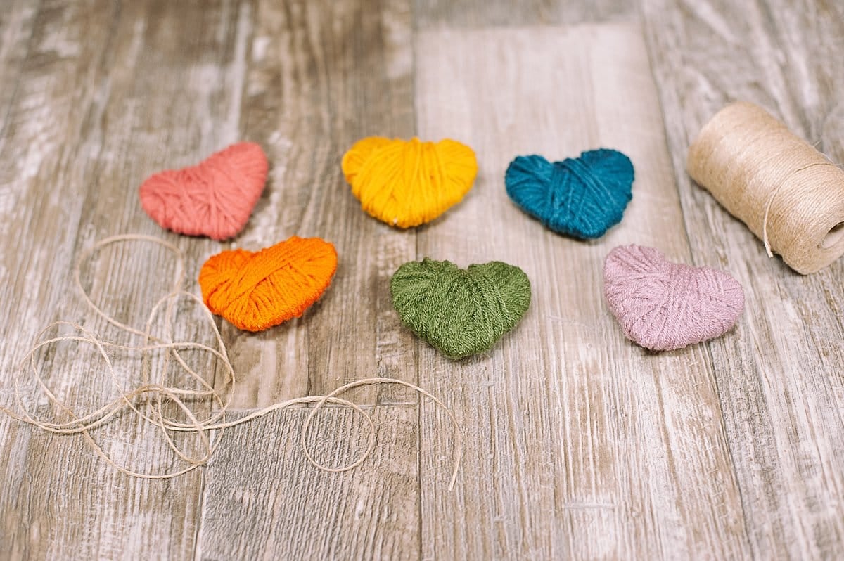 Yarn wrapped hearts and a long piece of twine.