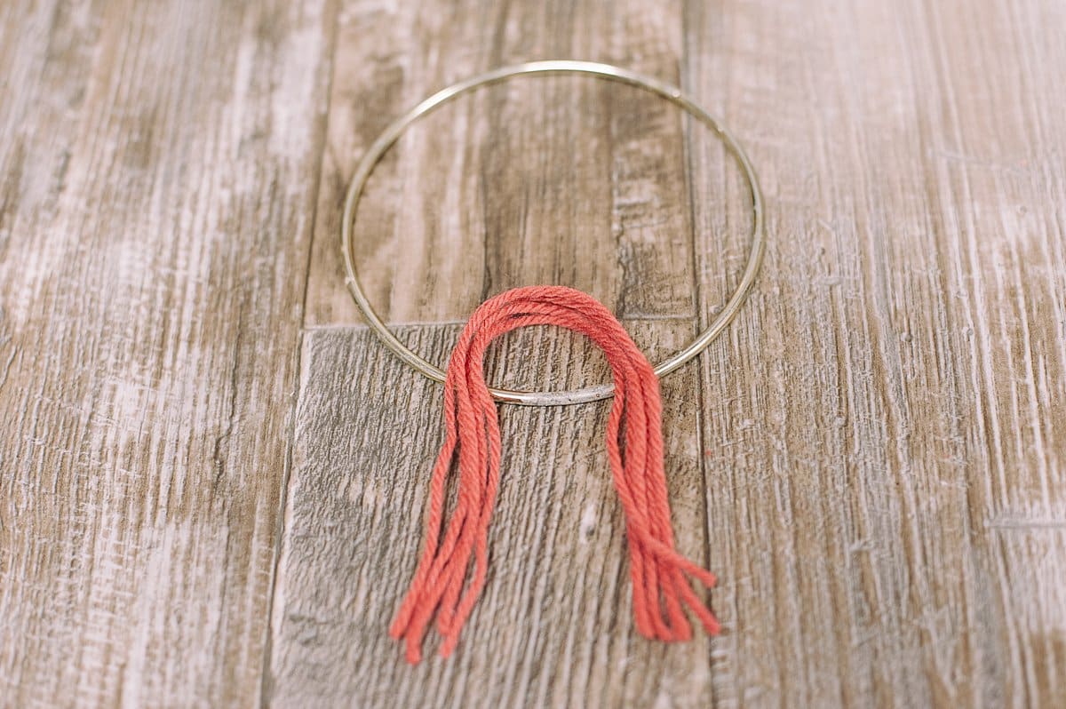 tie yarn onto loop with a lark's head knot