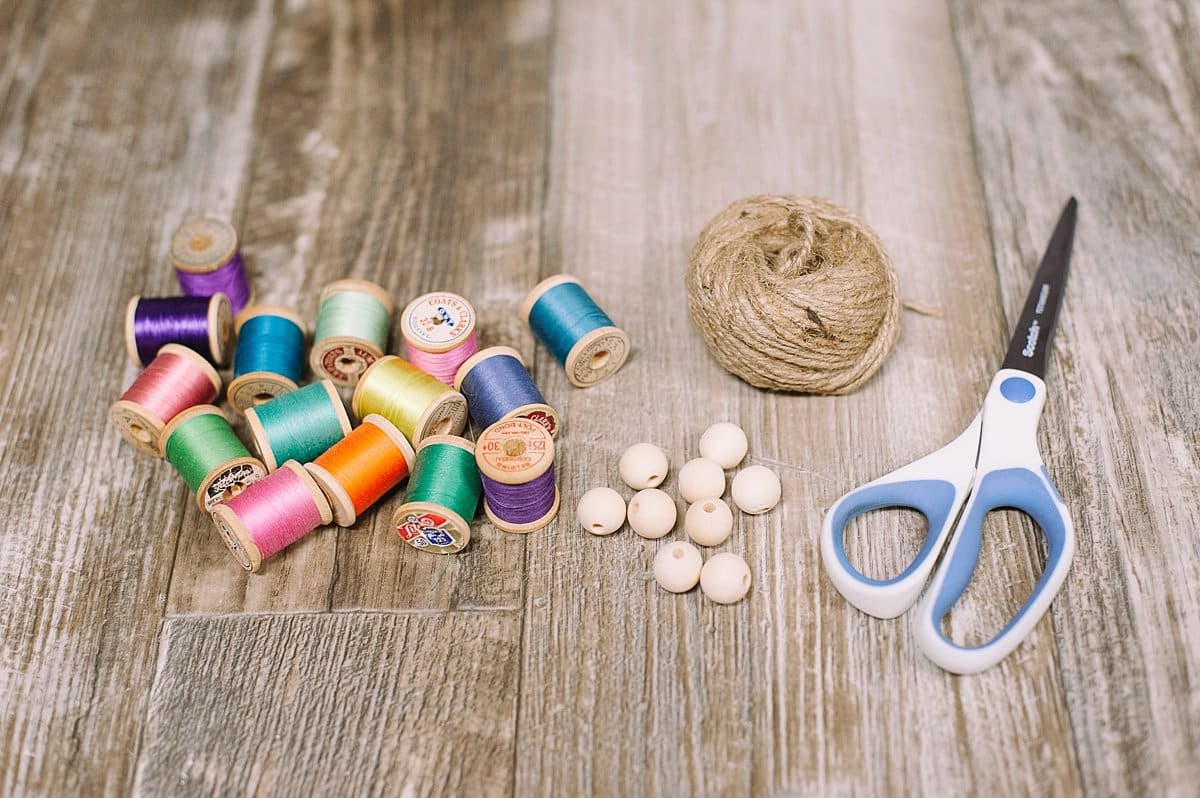 Supplies needed to make a summer garland of vintage thread spools.