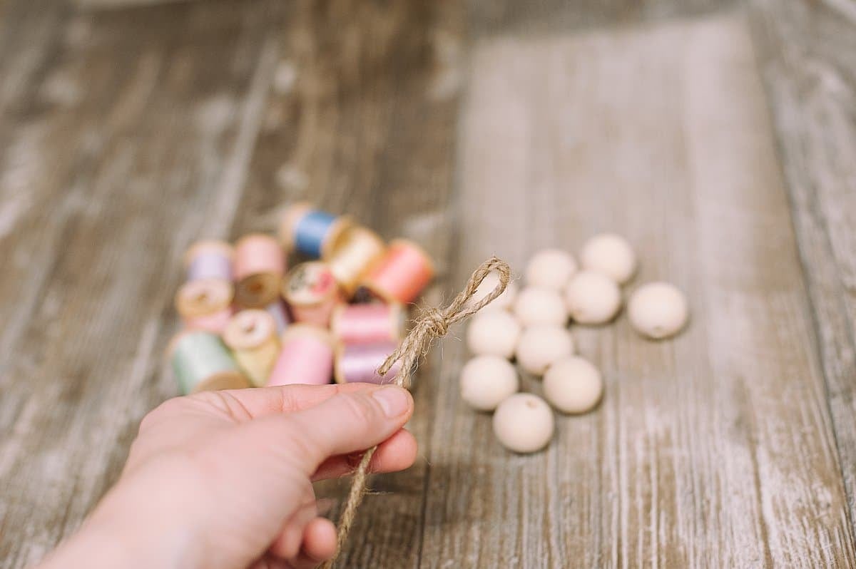 Tie a knot at the end of the twine for your spring garland.