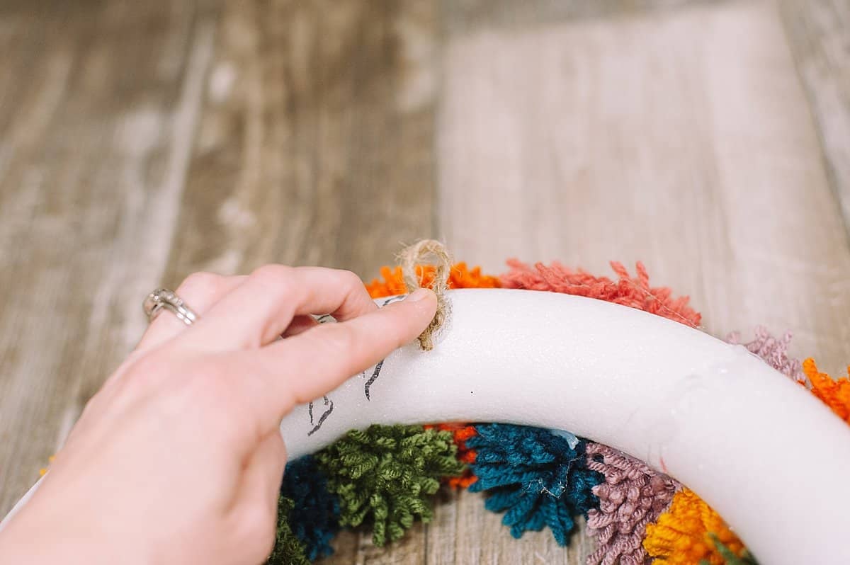 hot glue hanging string to the back of the wreath