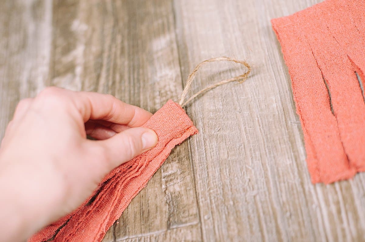 roll the fabric up into a tassel and glue the end