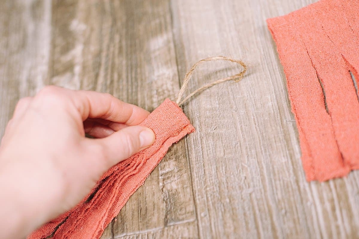 roll the fabric up into a tassel and glue the end