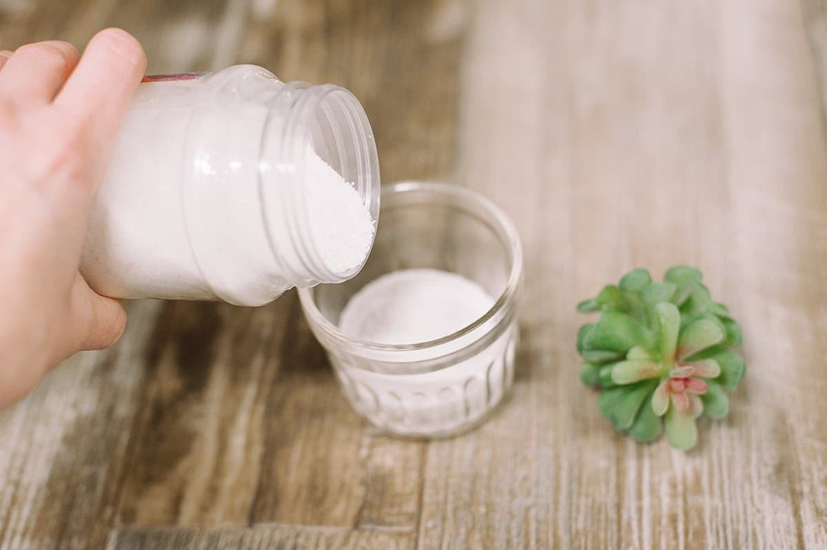 pour sand into the bottom of a jar