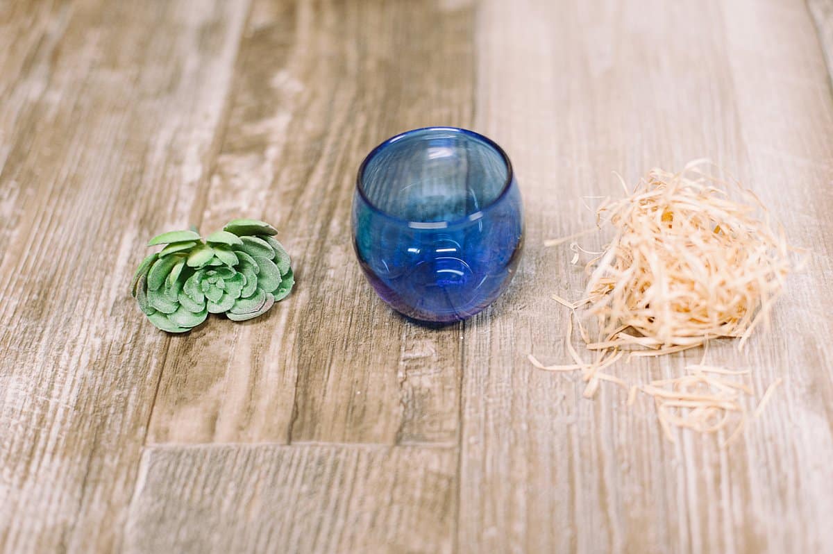 use shredded straw or raffia as a filler for a faux succulent container