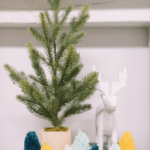 how to make DIY yarn pompom trees for christmas with yarn, wine corks, and hot glue