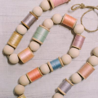 How to Make a Garland for Spring with Wood Beads and Spools of Thread