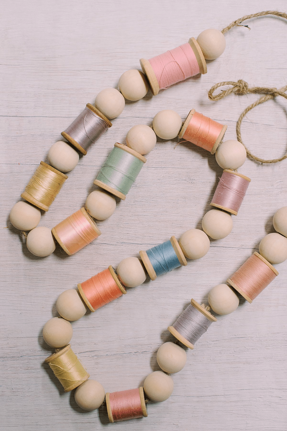 How to Make a Garland for Spring with Wood Beads and Spools of Thread