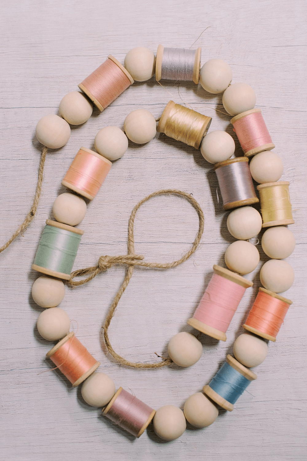 How to Make a Garland for Spring with Wood Beads and Spools of Thread