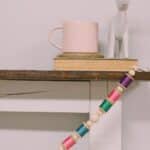 How to make a colorful garland with wood beads and thread spools.