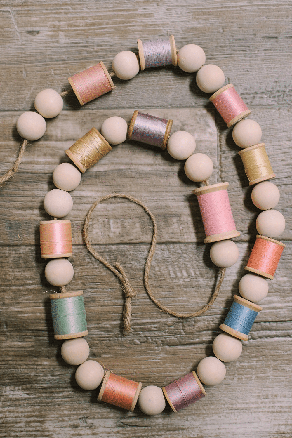 How to Make a Garland for Spring with Wood Beads and Spools of Thread