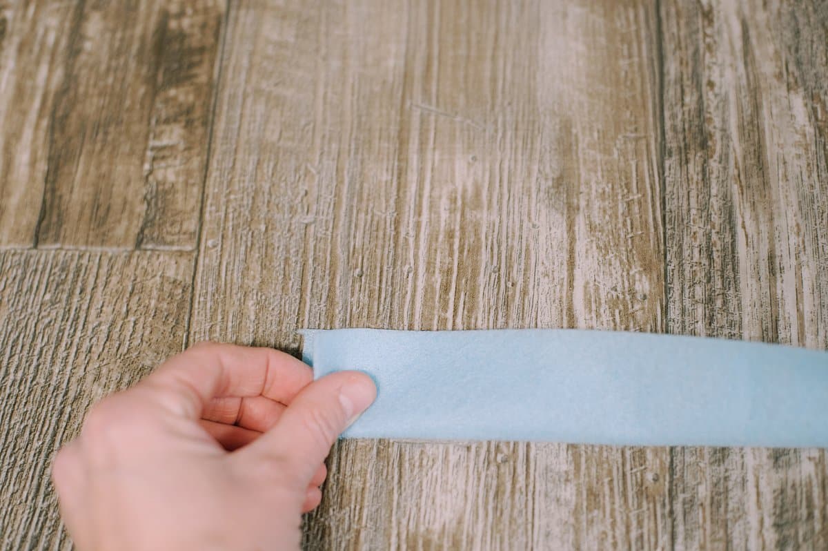 Fold and glue a felt strip in half.