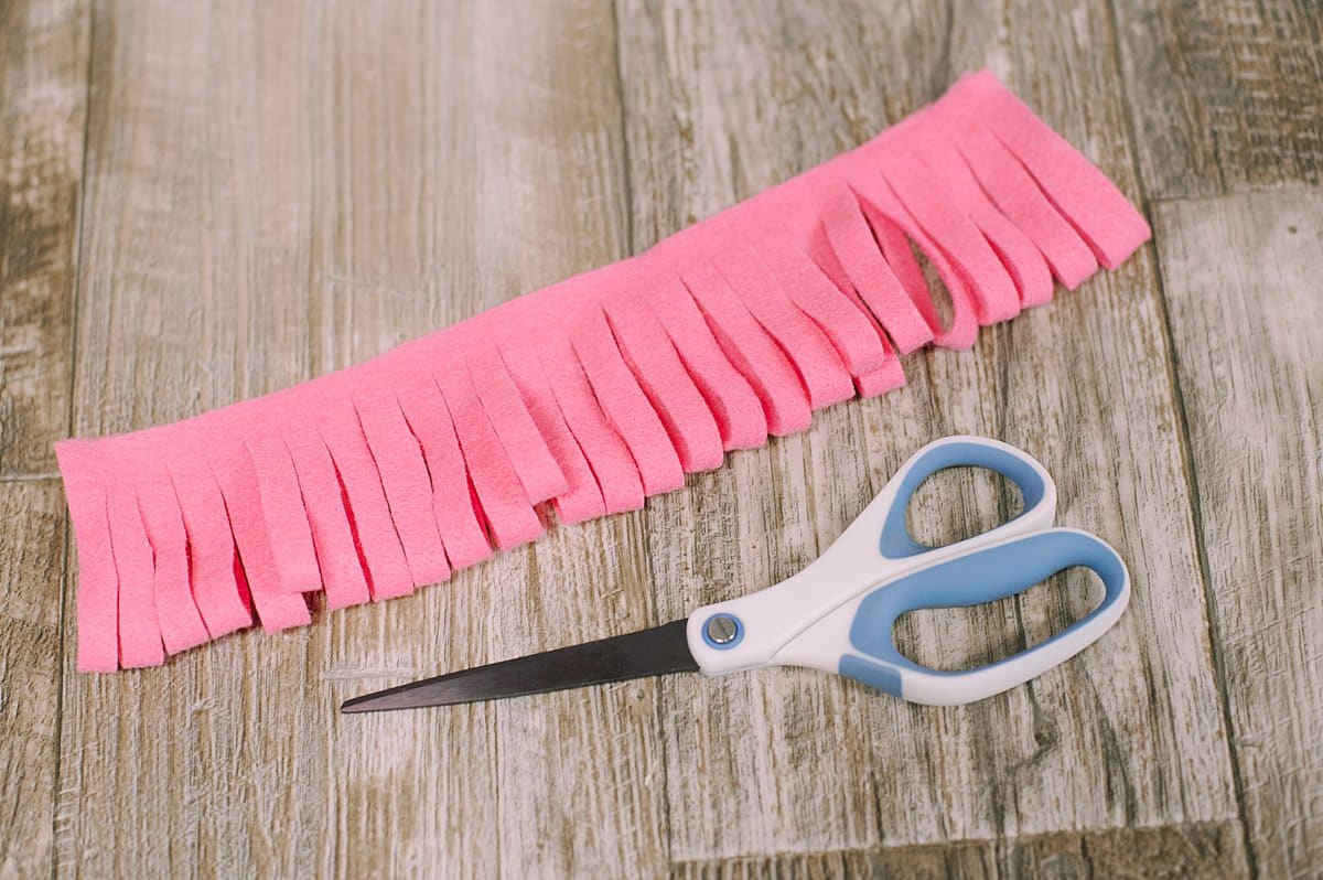 A piece of felt with fringe cut into the bottom edge.
