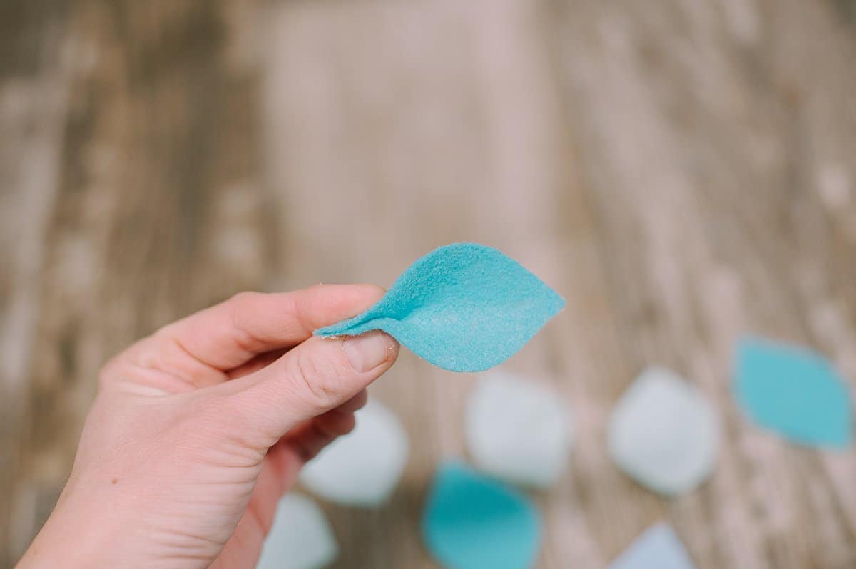 Felt flower petal with hot glue on one end and the edges pinched together.