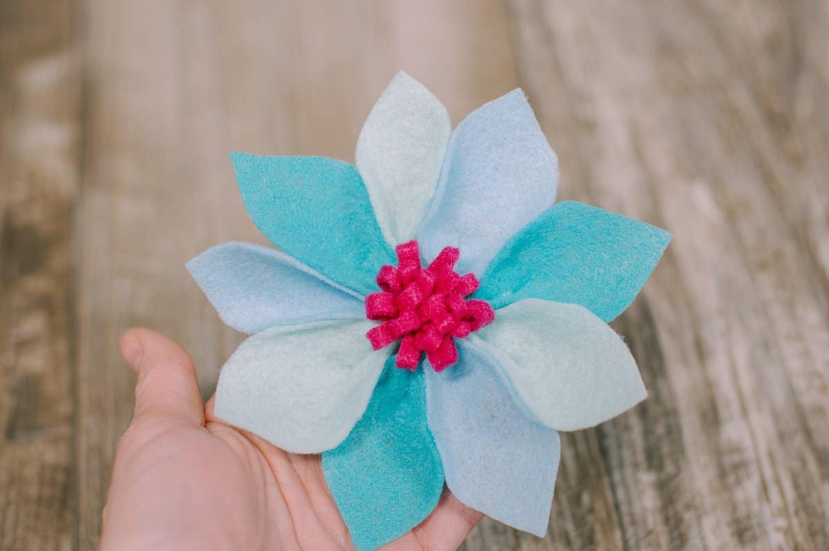 Felt petal flower with alternating colored petals and felt mum center.