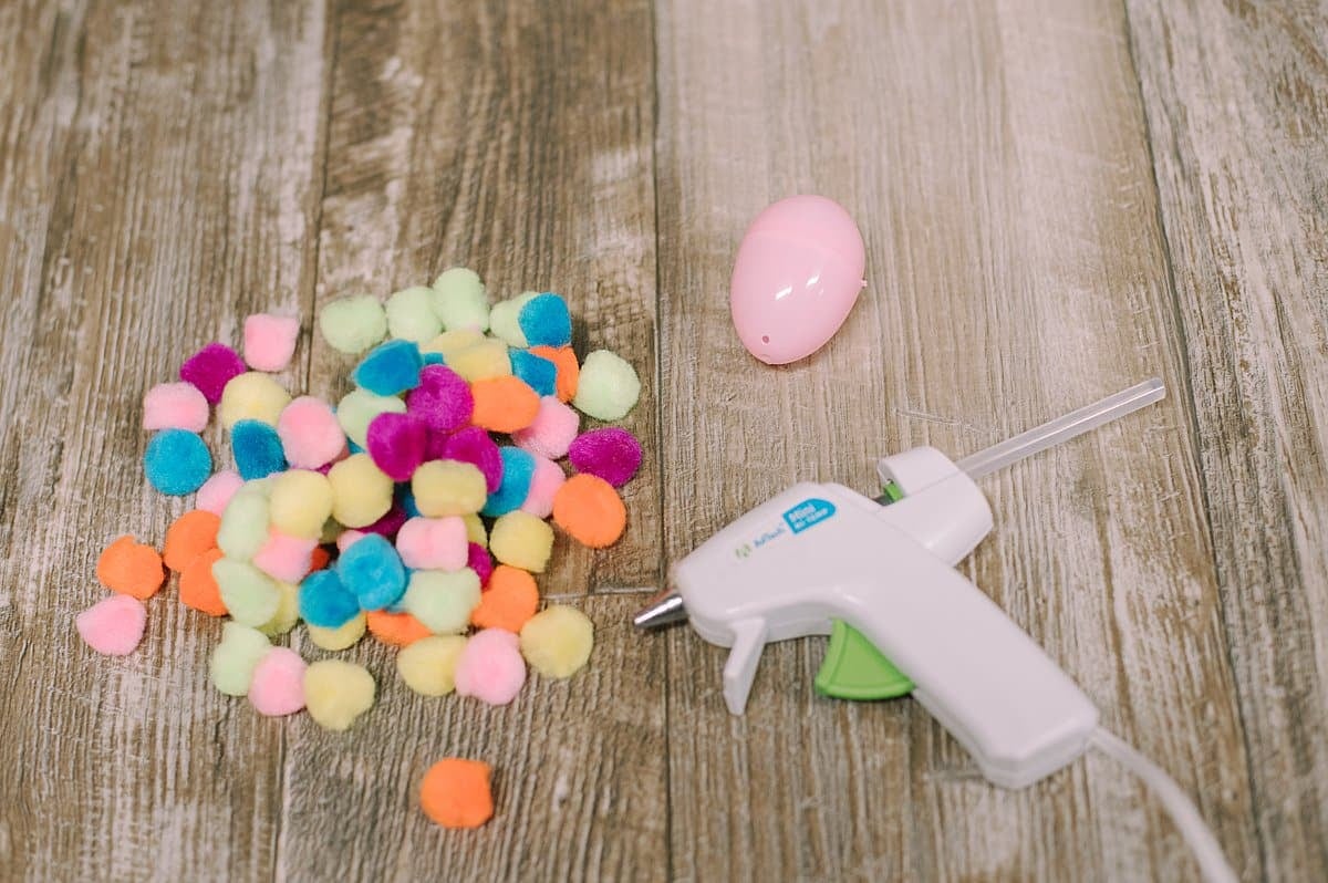 supplies to make a pompom covered plastic easter egg