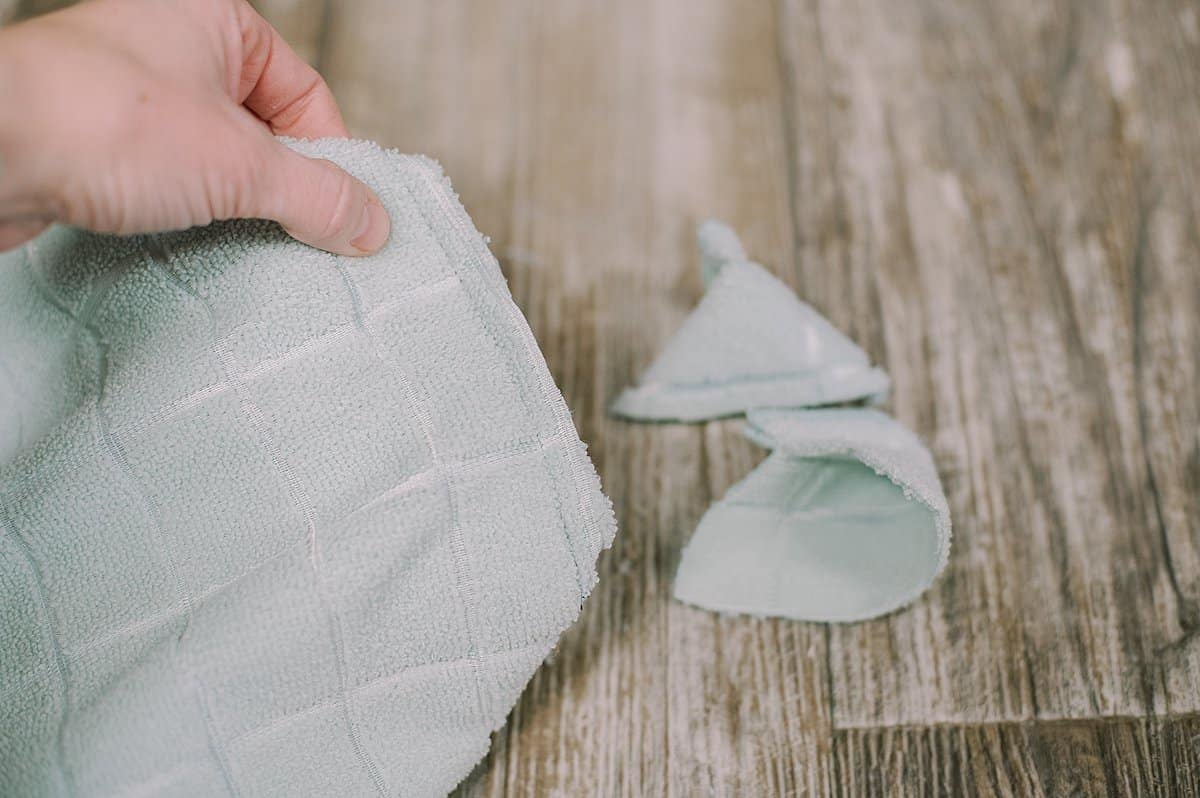 cut the edges off of the flat bottom of the tote bag