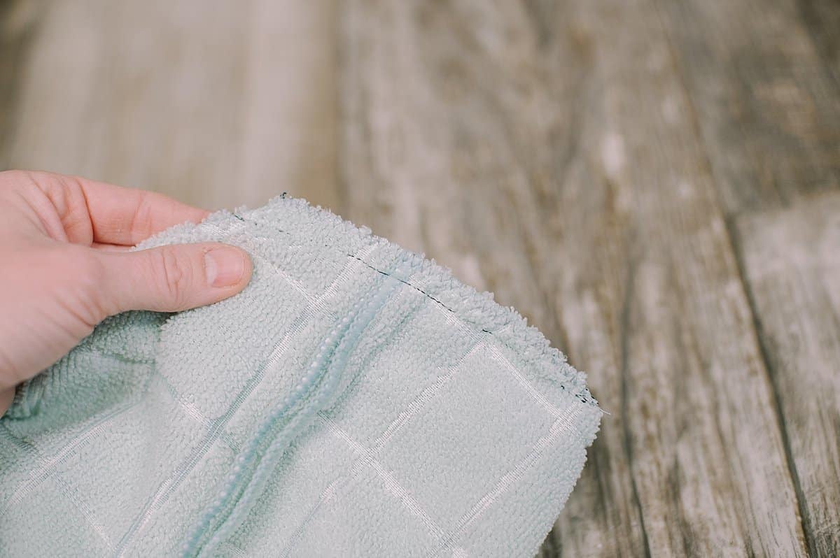 zig zag along the edge of the hand towel fabric to keep it from fraying