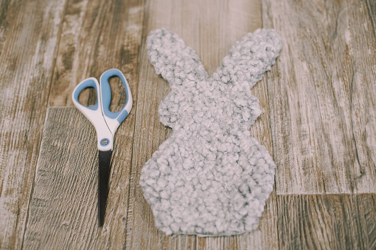 A fabric bunny shape and a pair of scissors.