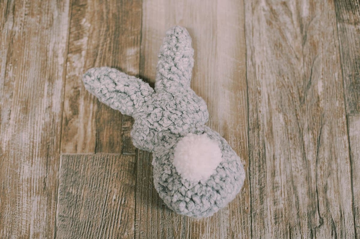 A handmade DIY stuffed bunny rabbit with a yarn pompom tail.