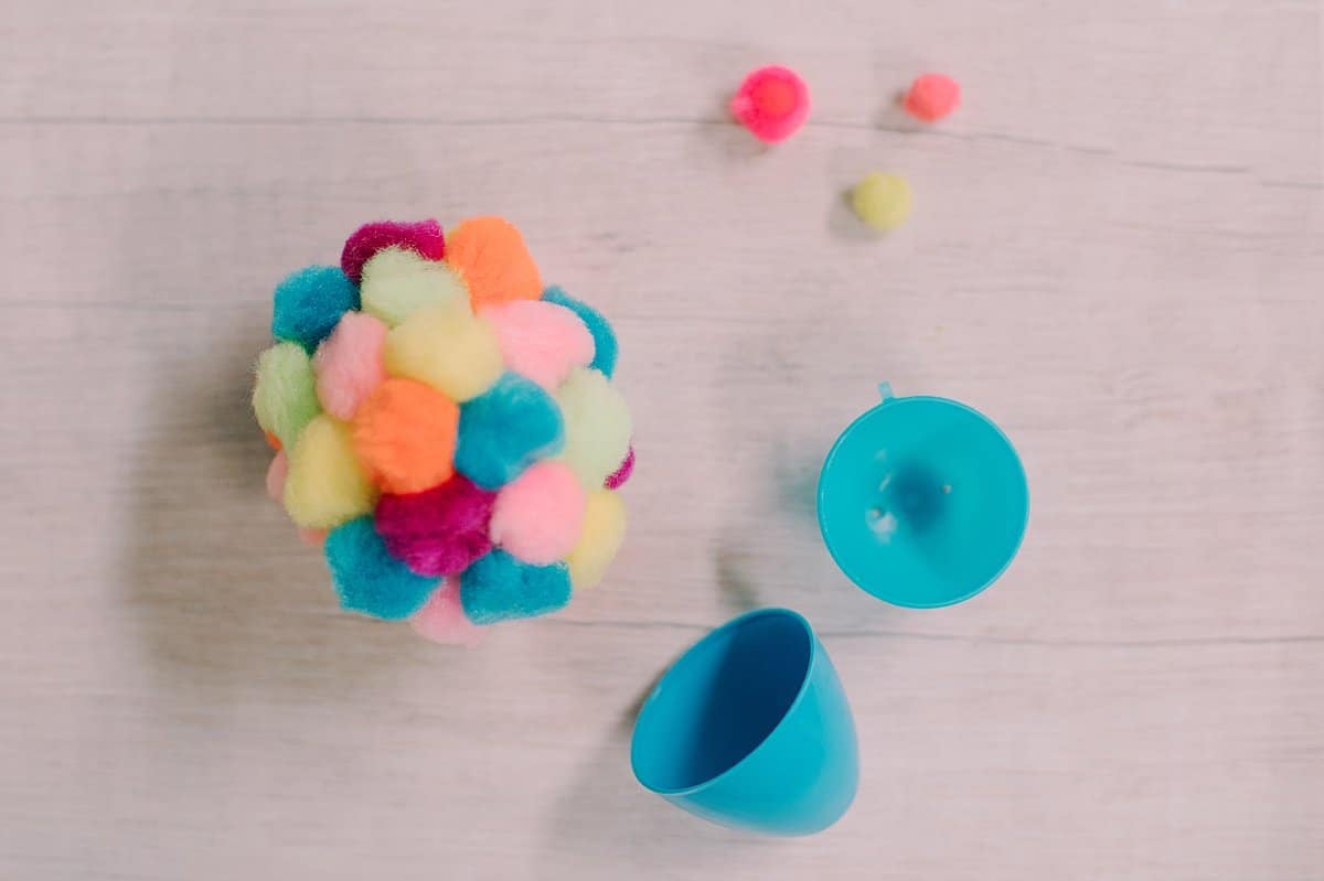 pompoms hot glued to plastic easter egg