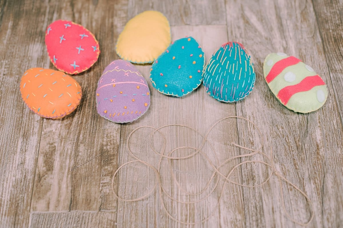 Colorful handmade felt easter eggs and a twine string.