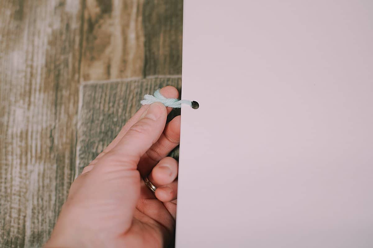 printer paper three hole punched and tied into a book