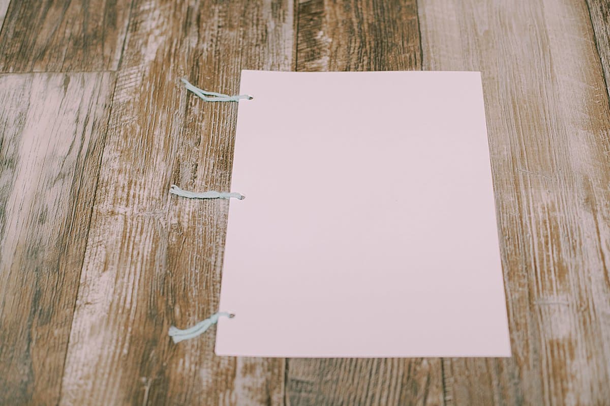 printer paper three hole punched and tied into a book