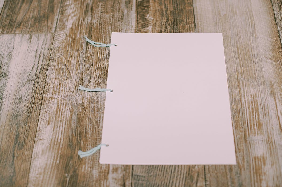 printer paper three hole punched and tied into a book