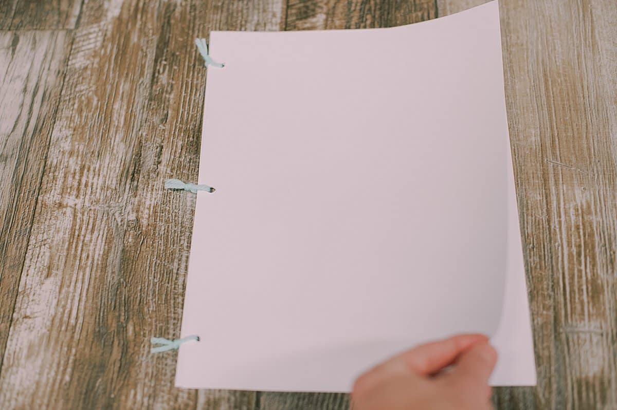 printer paper three hole punched and tied into a book