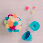 How to Make Pompom-Covered Easter Eggs | Plastic Easter Eggs covered in pompoms using hot glue