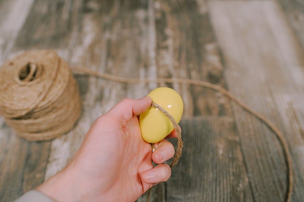 start wrapping twine around the plastic easter egg