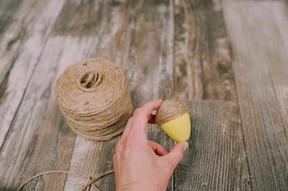 how to make DIY fall acorns using plastic easter eggs, yarn, and twine