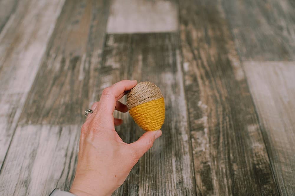 how to make DIY fall acorns using plastic easter eggs, yarn, and twine