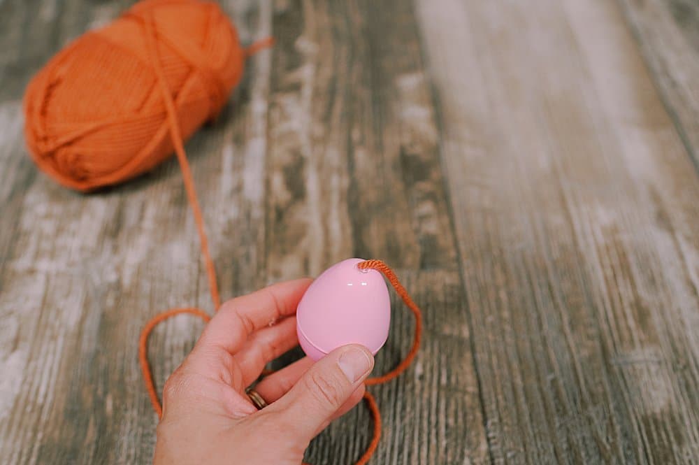 hot glue yarn to the plastic easter egg to make a fall acorn