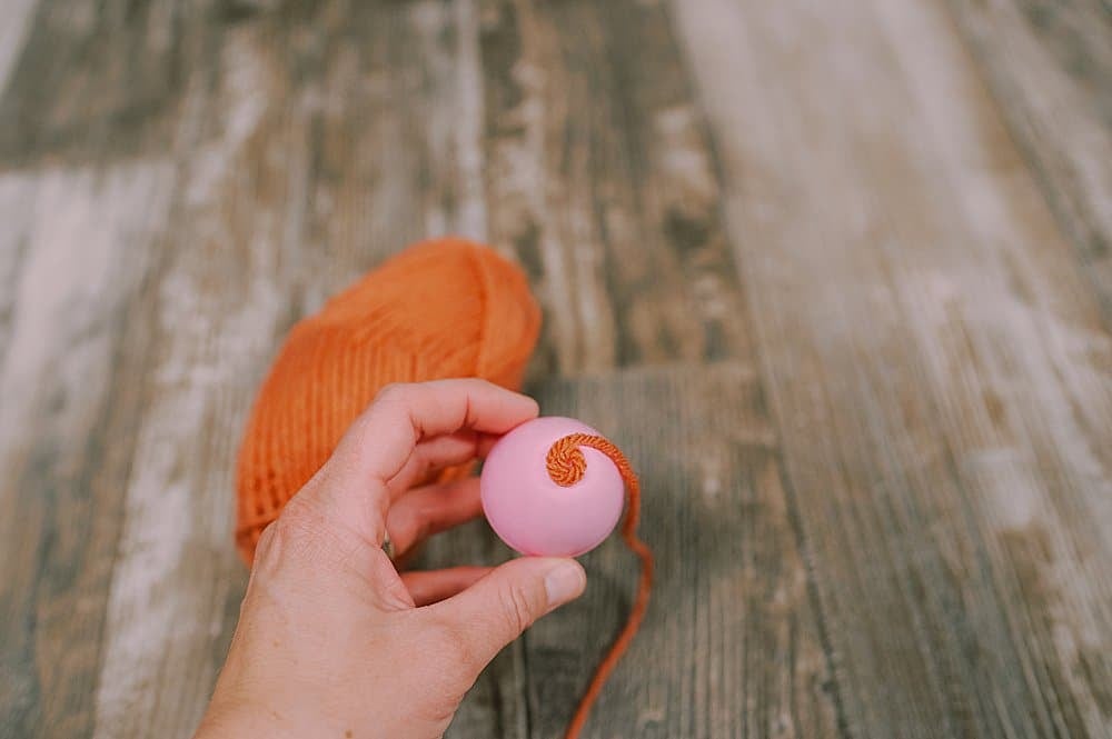 hot glue yarn to the plastic easter egg to make a fall acorn