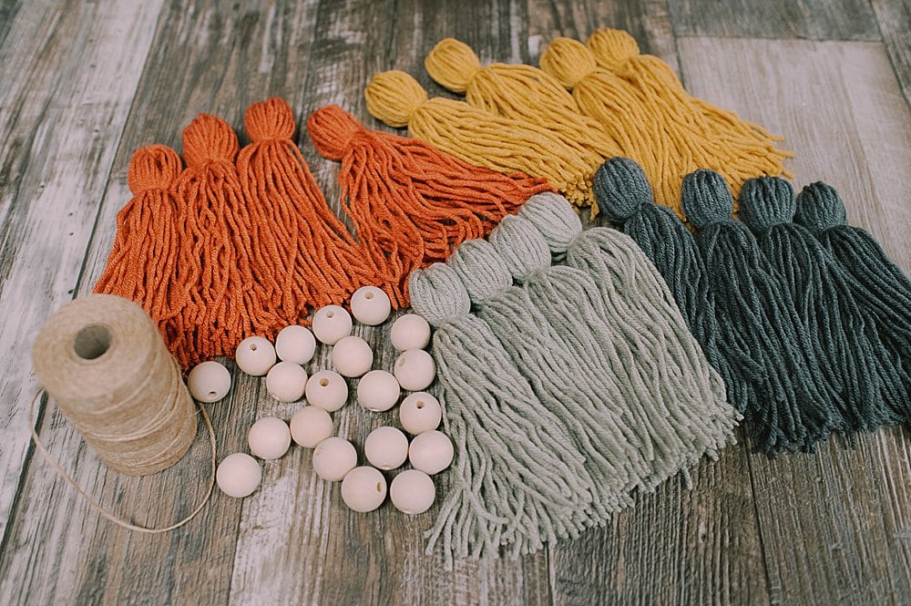 how to make a fall-colored yarn tassel garland