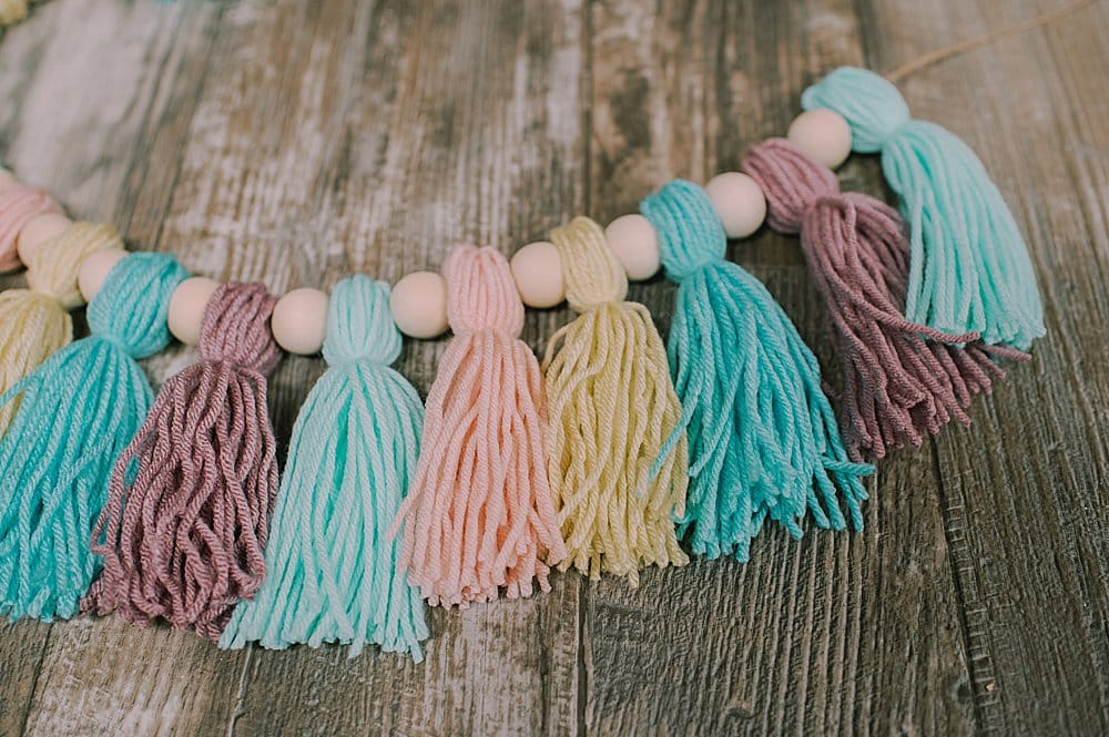 yarn tassels with wooden beads between them
