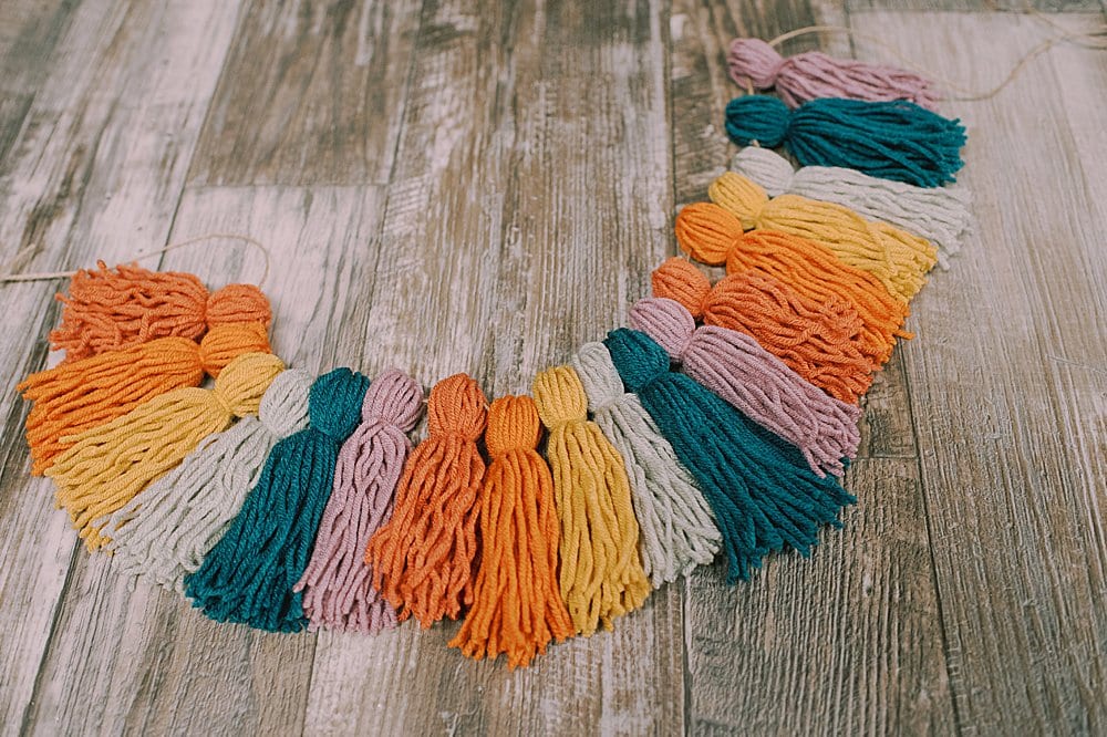 rainbow colored yarn tassels and twine to string it to a garland