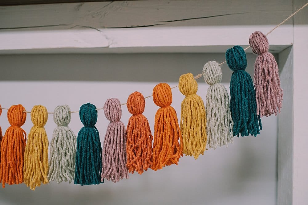 how to make a rainbow yarn tassel garland