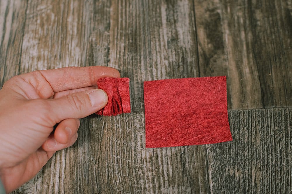 Piece of red felt cut and rolled into a flower.