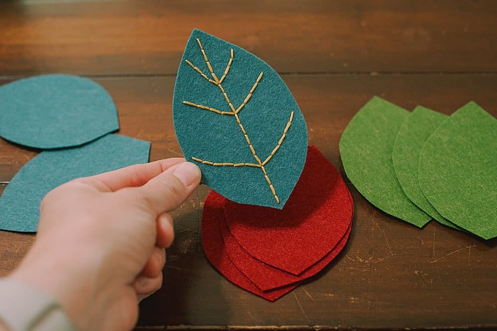 embroider veins into the felt leaf shapes using embroidery floss