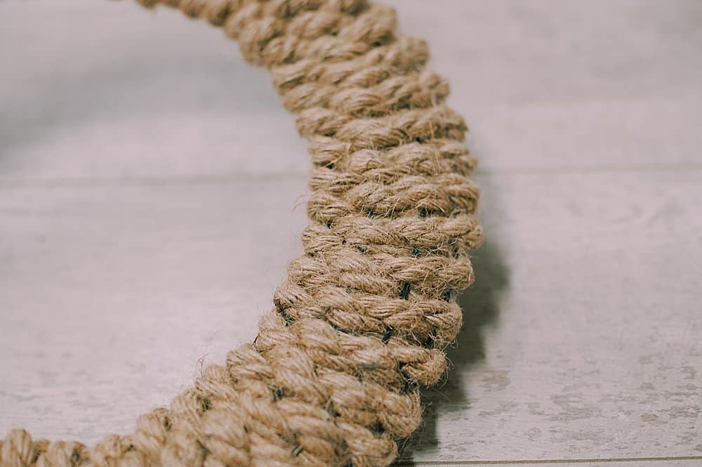 A rope wreath with a woven texture.