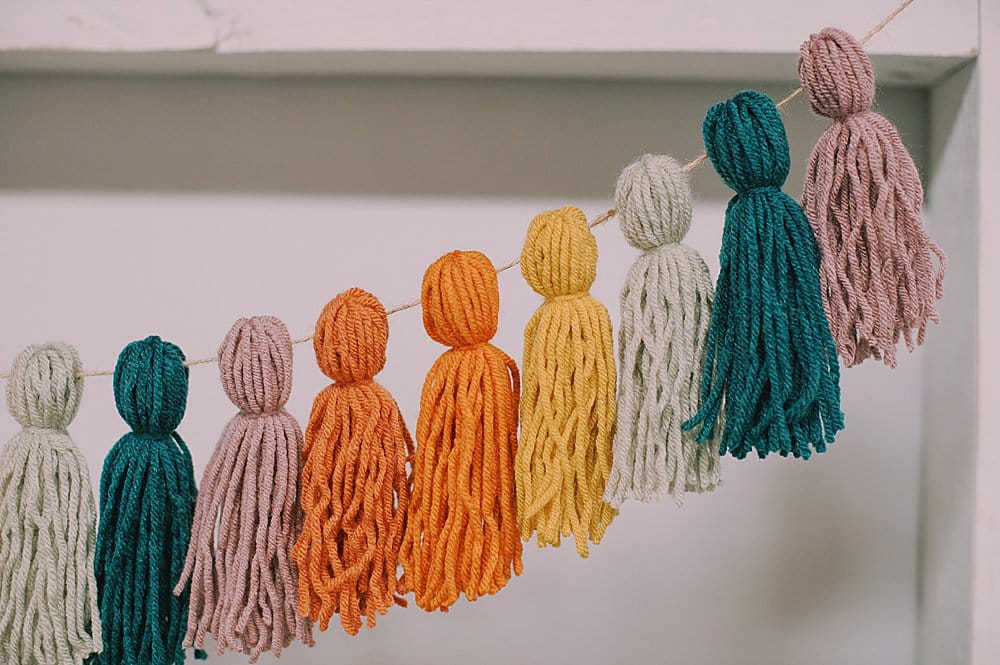 how to make a rainbow yarn tassel garland
