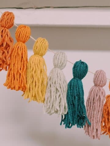 How to make a rainbow yarn tassel garland
