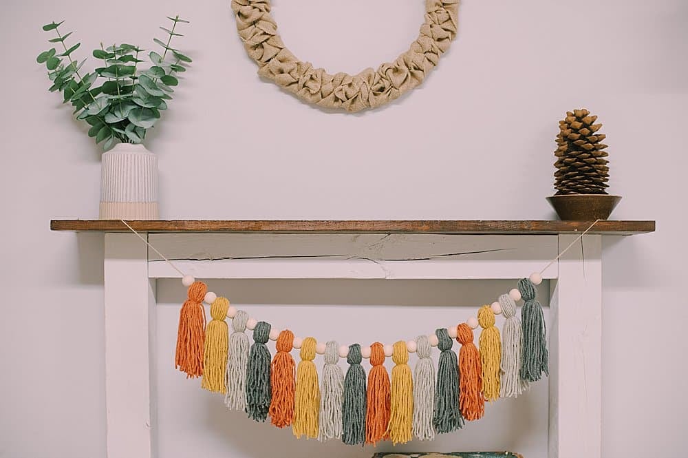 how to make a fall-colored yarn tassel garland
