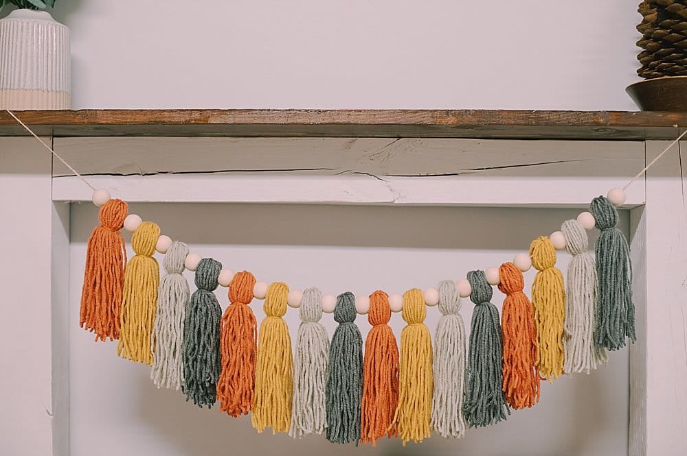 how to make a fall-colored yarn tassel garland