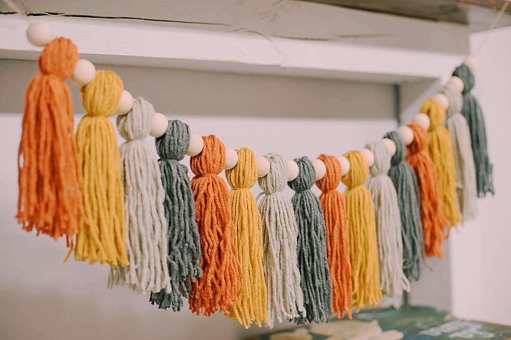 how to make a fall-colored yarn tassel garland